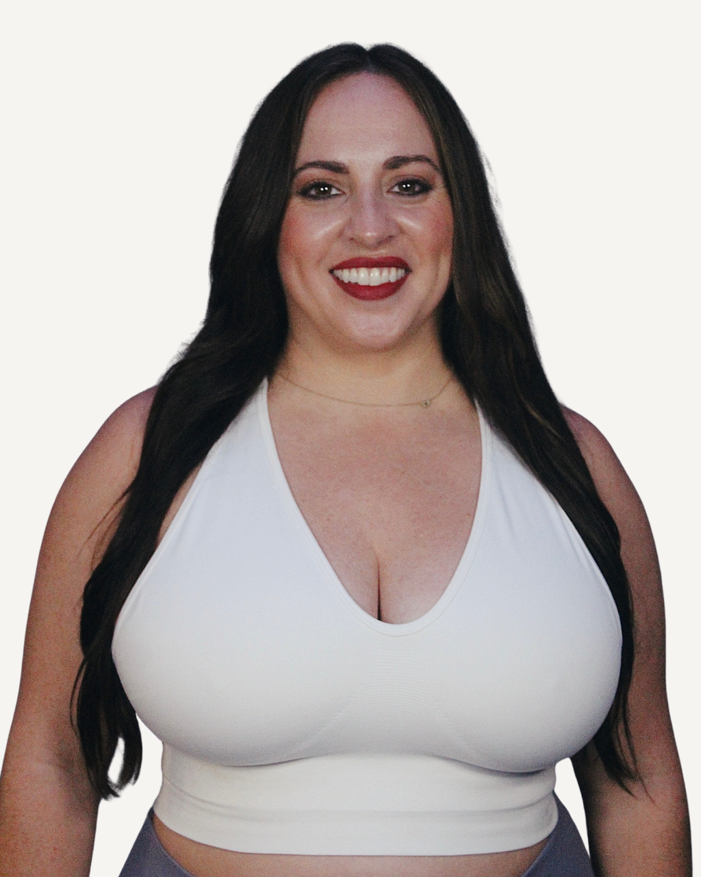 Woman wearing a white everyday bra, designed to flex across sizes 30G–32H comfortably. 