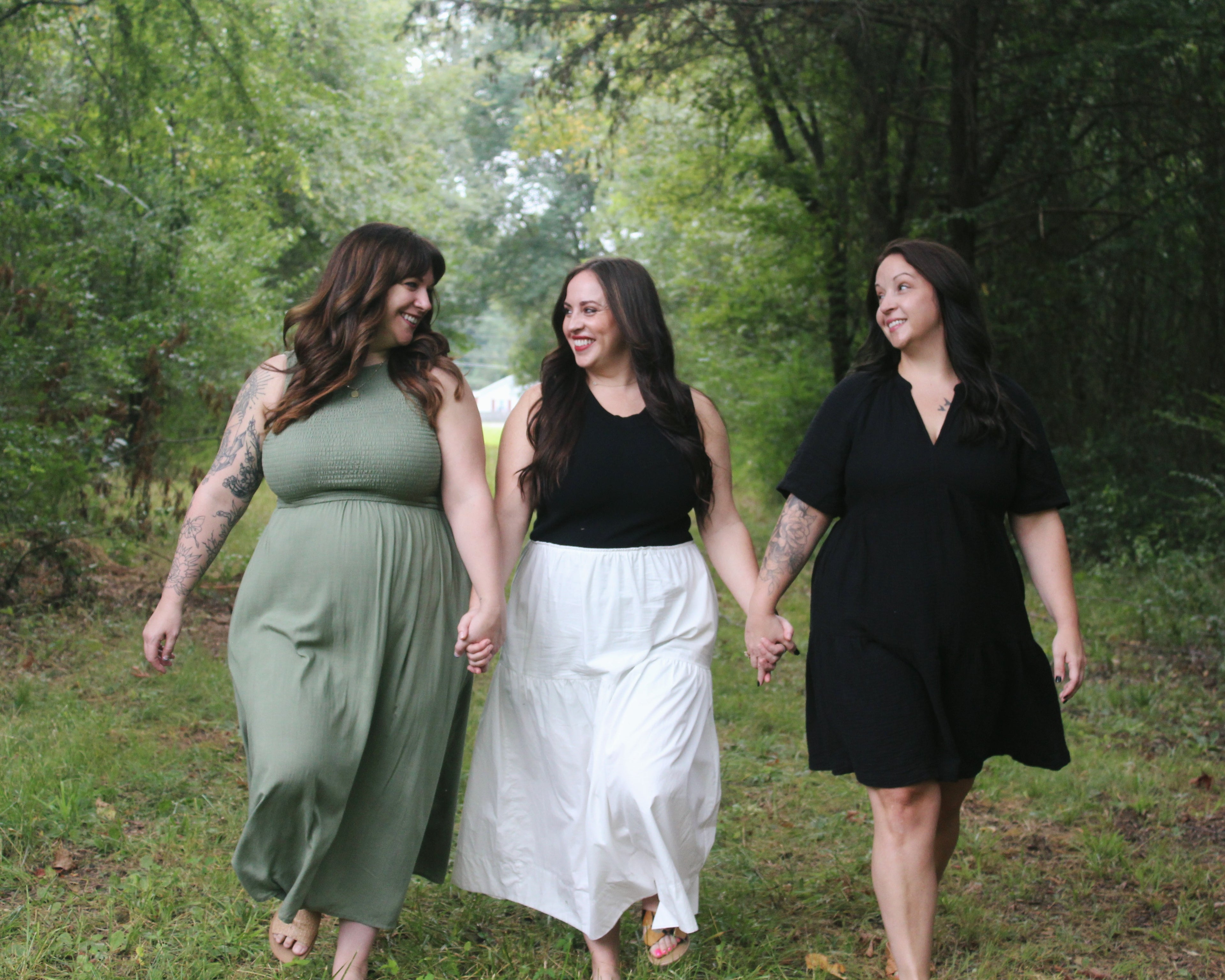 Three women walking hand in hand showcasing comfortable bras.