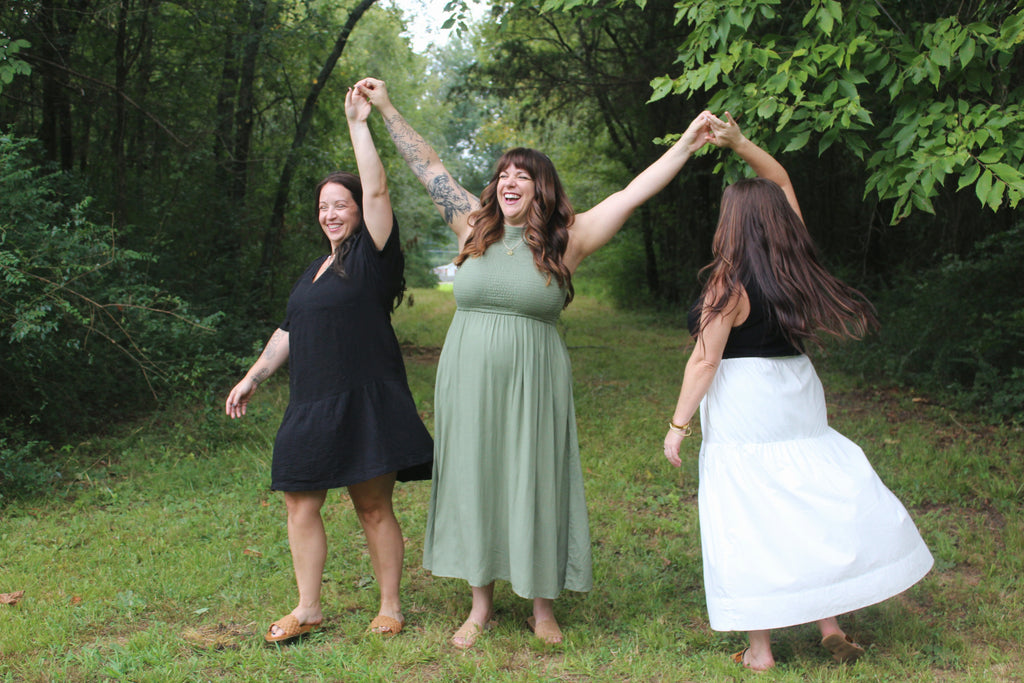 Three women showcasing the smooth fit of our bras under clothing.